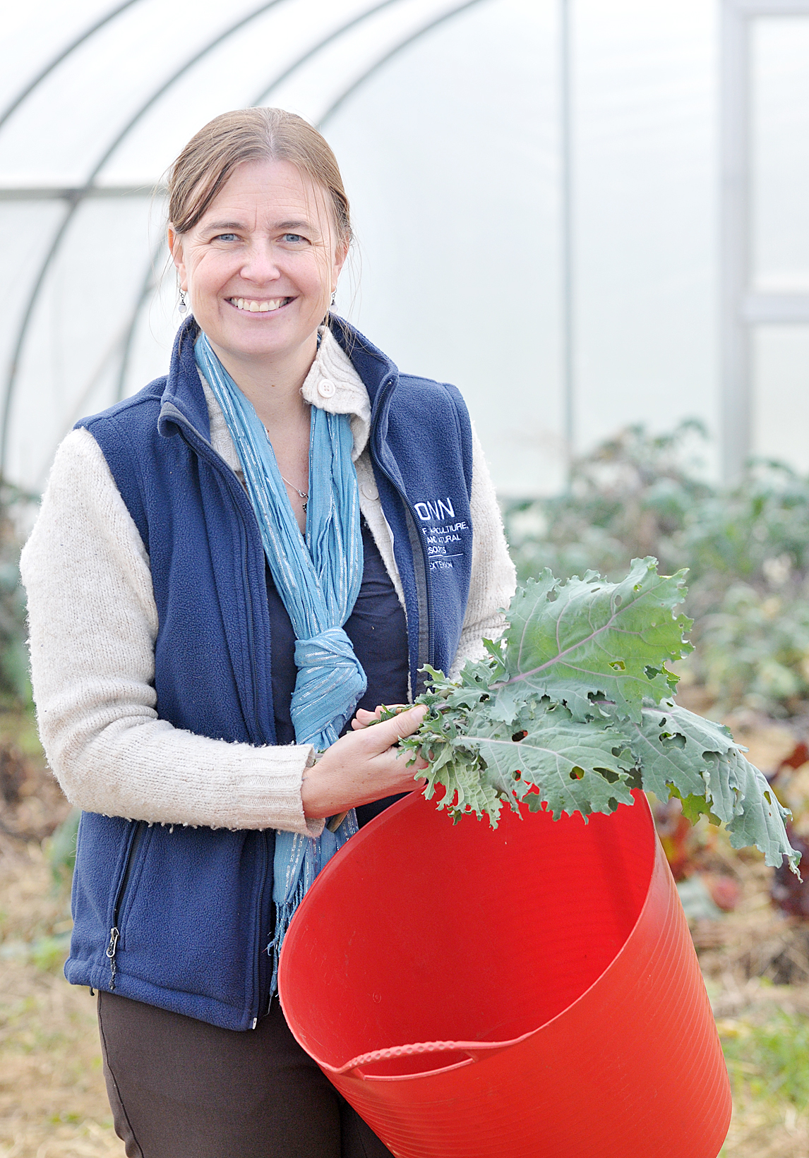 Jiff Martin in the green house collecting kale